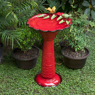 Red Metal Birdbath with Birds and Leaves